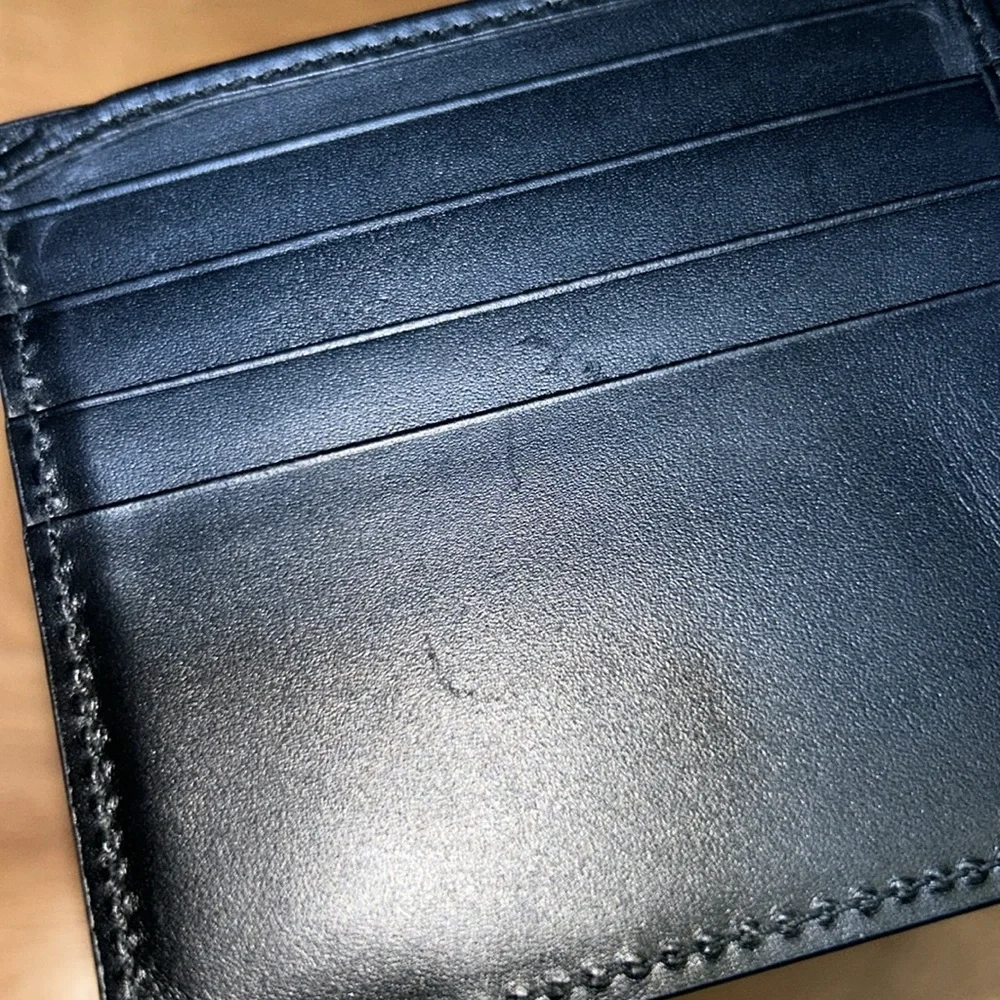 Authentic Gucci Dorian Signature Embossed Leather Bifold Wallet